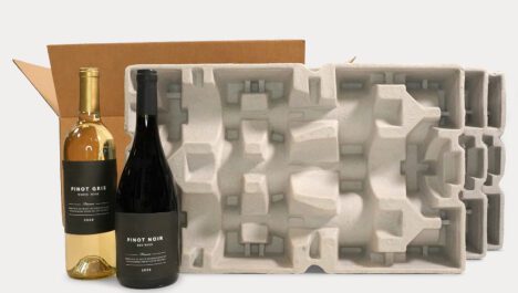 Two wine bottles next to pulp packaging