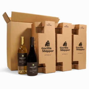 Two wine bottles next to corrugated inserts and an outer box
