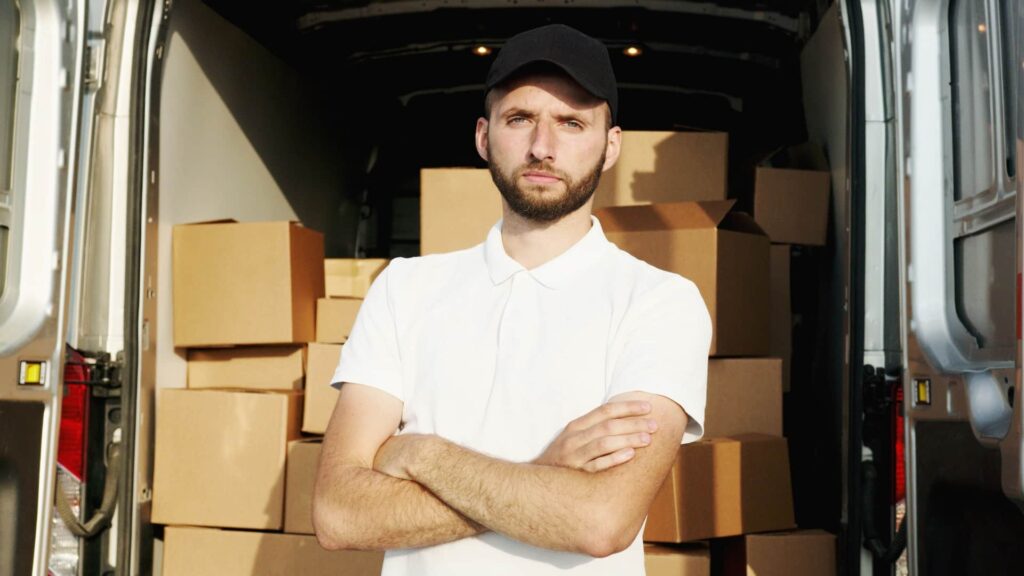 A man standing at the back of a delivery truck