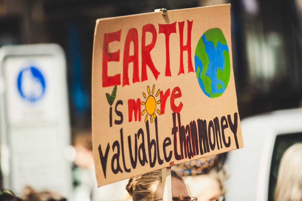 A woman holding a protest sign about climate change