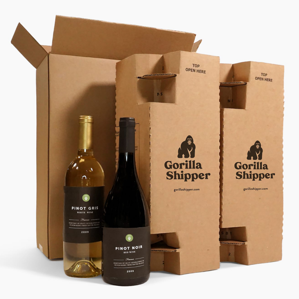 Two wine bottles next to cardboard packaging