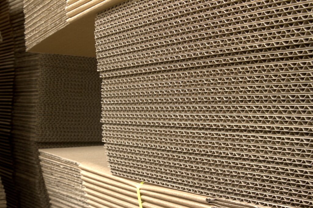 Stacks of corrugated cardboard lying flat