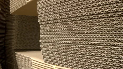 Stacks of corrugated cardboard lying flat