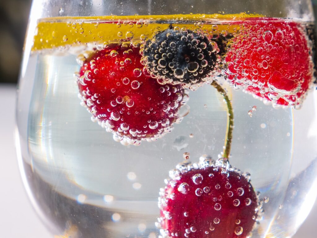 Cherries inside a wine glass with sparkling water