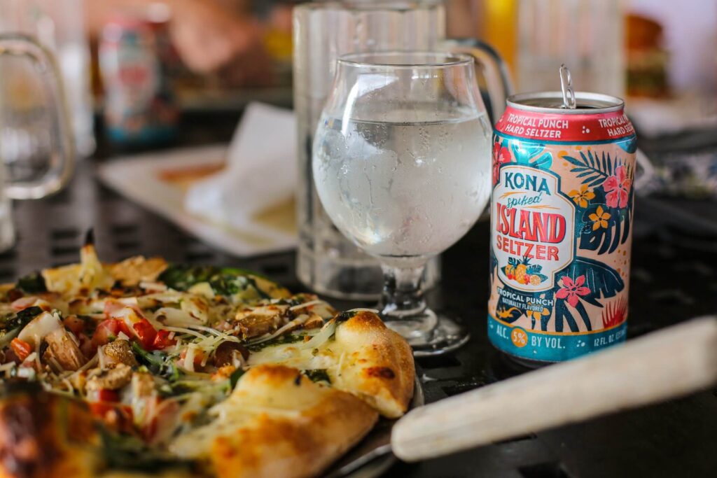 Glass of seltzer with pizza