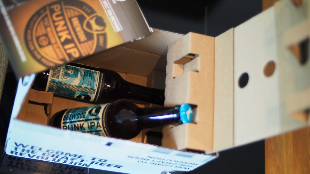 A cardboard box with beer bottles