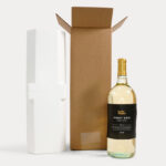 A wine bottle in front of foam packaging