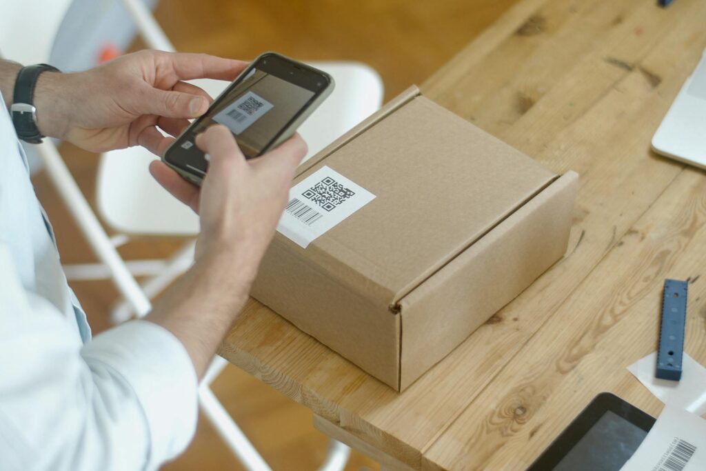 A person scanning a box with a QR code