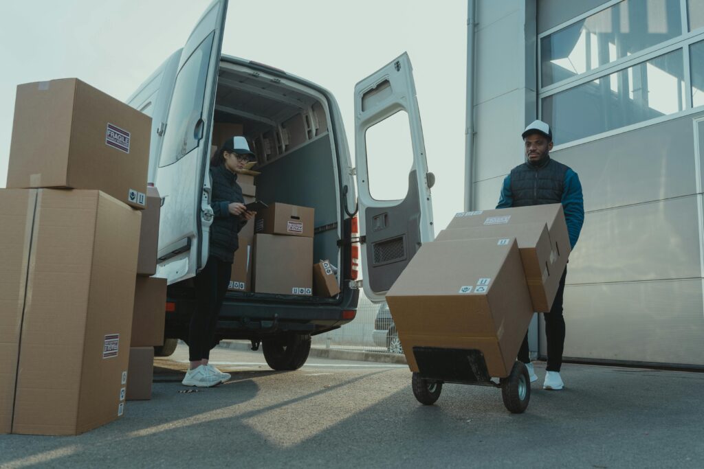 A man carrying boxes to a van