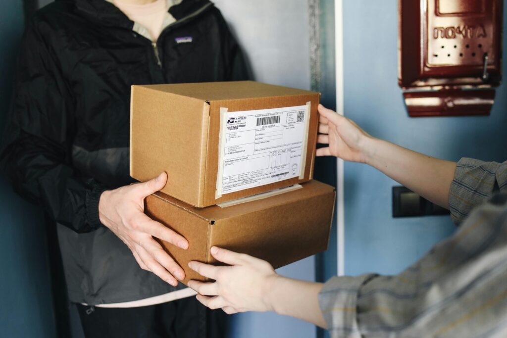 A person handing over boxes to the recipient