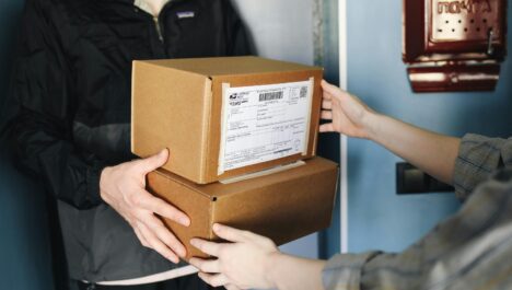 A person handing over boxes to the recipient