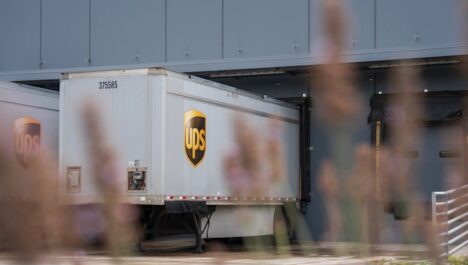 Shipping tractor trailer at a warehouse loading dock.