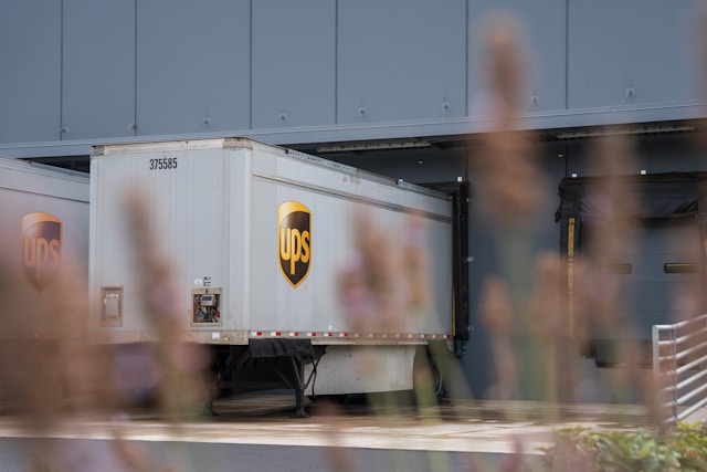 Shipping tractor trailer at a warehouse loading dock.